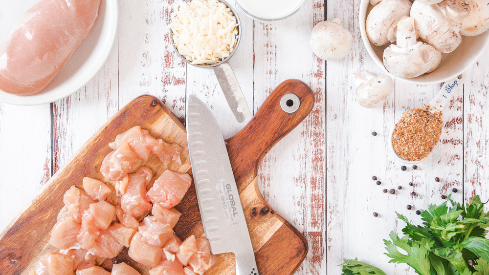 Dicing chicken on cutting board