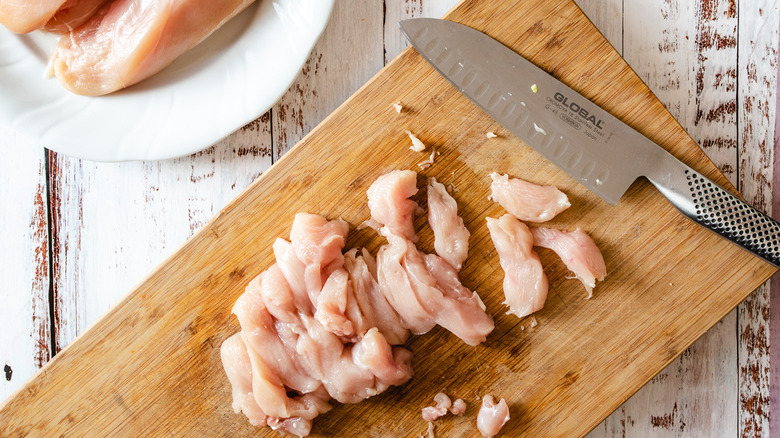 dicing chicken on cutting board