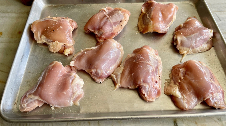 chicken thighs on a baking sheet