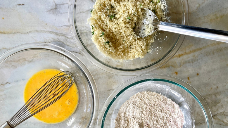 bowls of egg, flour, and panko for seasoning chicken