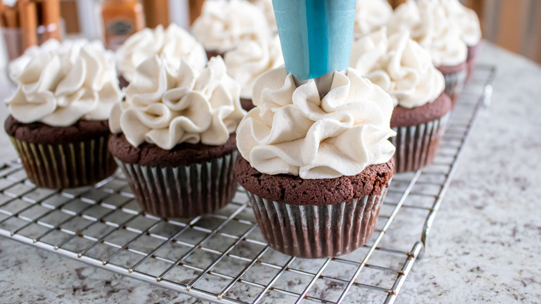 white frosting piped onto cupcakes