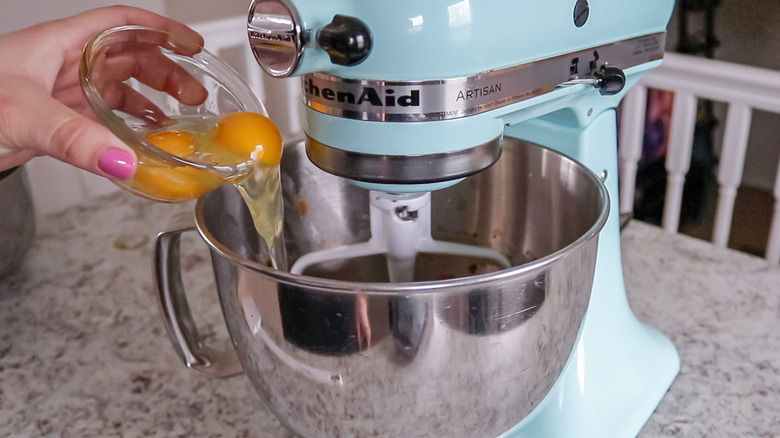 eggs poured into metal bowl