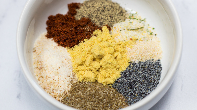 A white bowl of assorted spices and seasonings