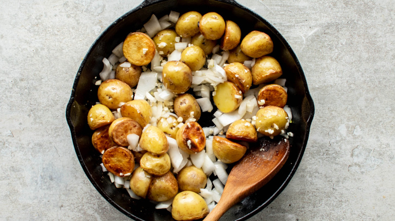 onion and potatoes in skillet 