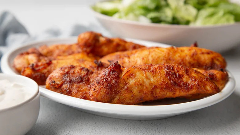 Chicken tenders on white plate