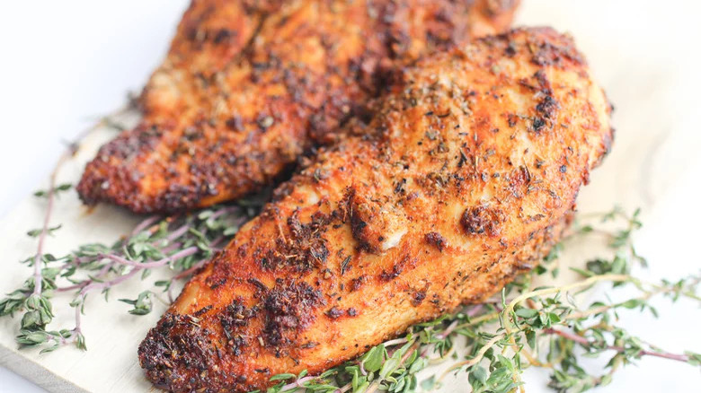 Seasoned chicken with herb garnish