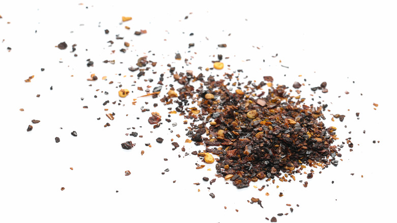 Dried ancho powder on white background 