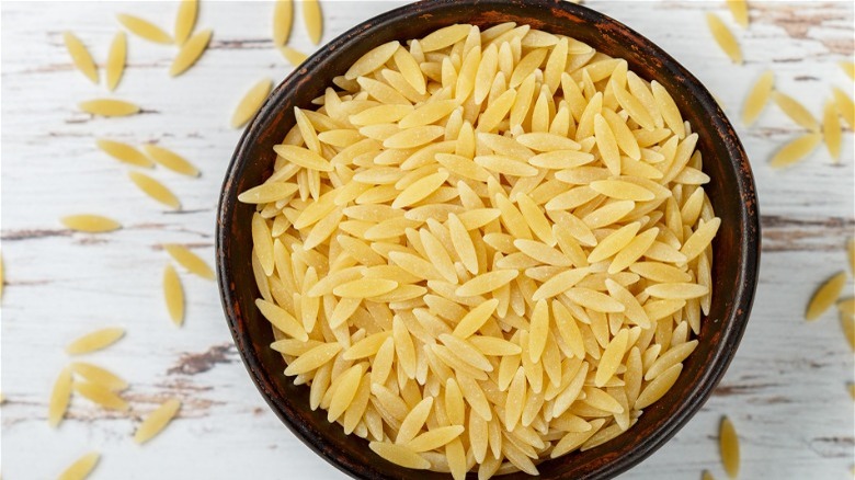 Wood bowl filled with orzo pasta