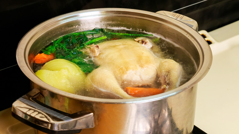A large silver pot with homemade chicken broth