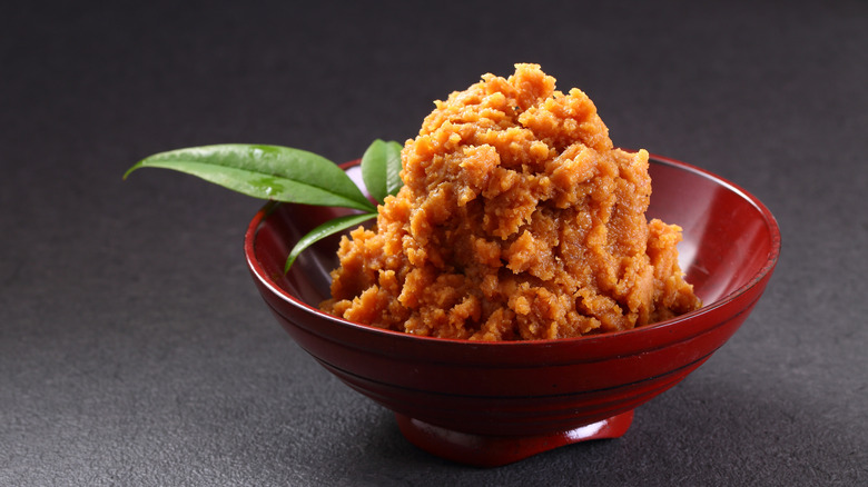 A red bowl of miso paste