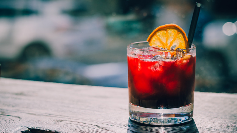 Red cocktail with an orange wheel