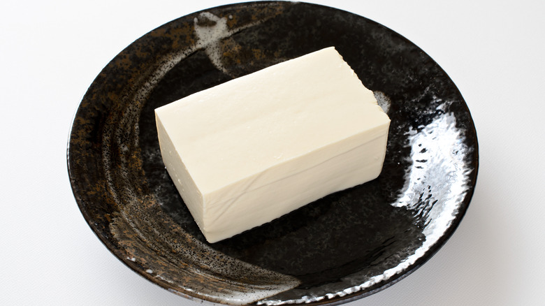 A block of silken tofu on a plate