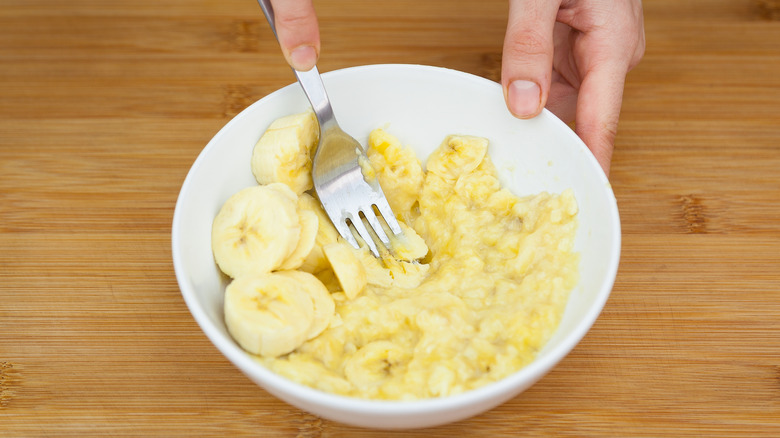 Woman mashing bananas