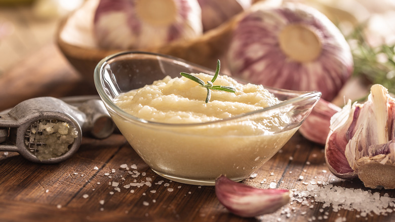 bowl of pureed garlic on cutting board