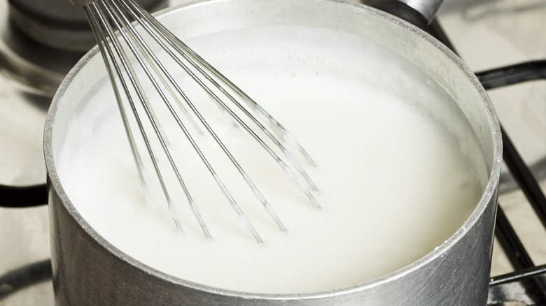 Whisking milk and cornstarch on a stove