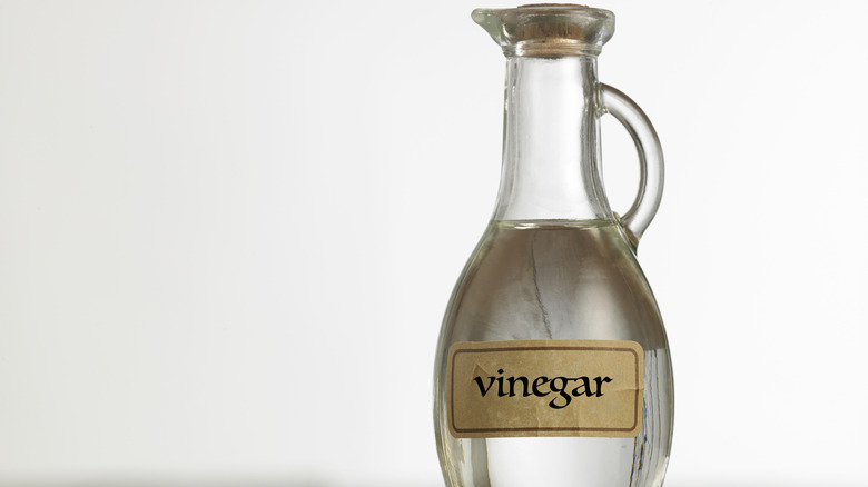 Clear corked bottle of white vinegar with label