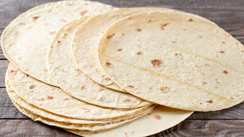 tortillas in pile on wooden table