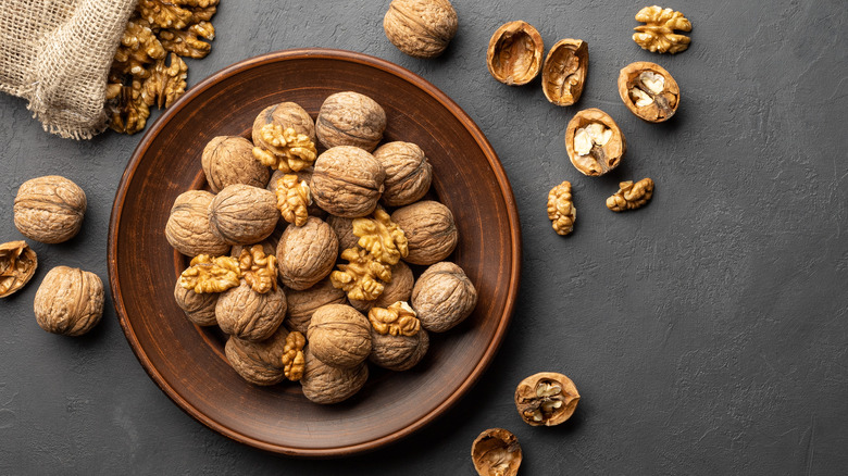 Shelled and unshelled walnuts in bowl