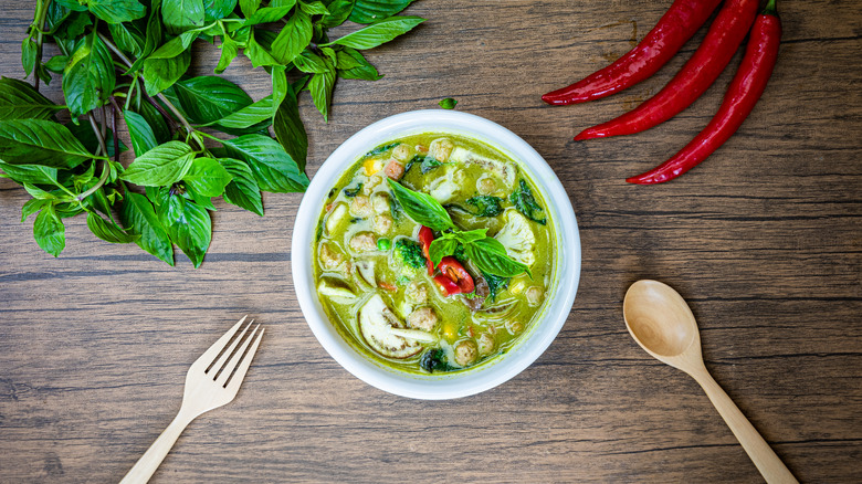 Green curry in a white bowl