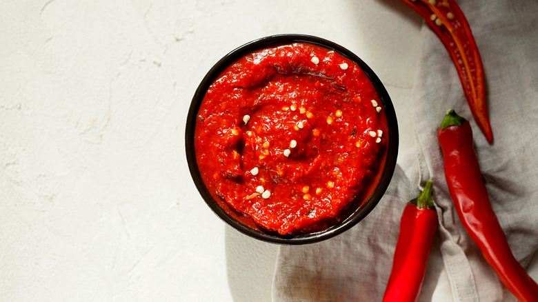 Tomato paste and chili peppers in a black bowl