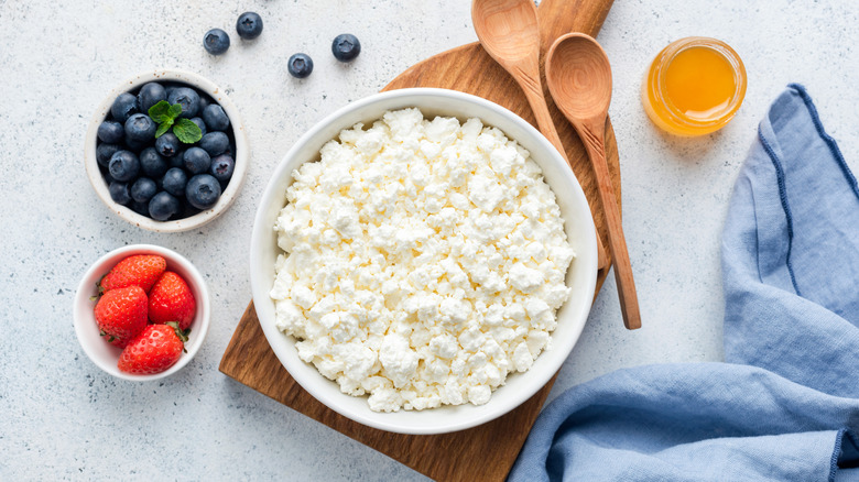 bowl of cottage cheese, bowls of blueberries and strawberries