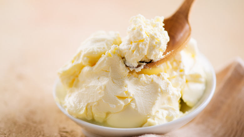 mascarpone in bowl with wood spoon