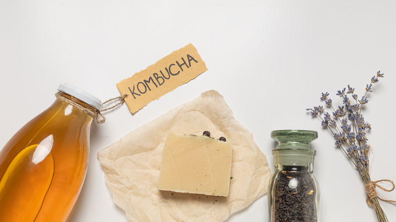 Homemade kombucha next to herbs