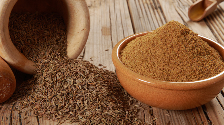 pinch bowls of cumin and fennel seeds