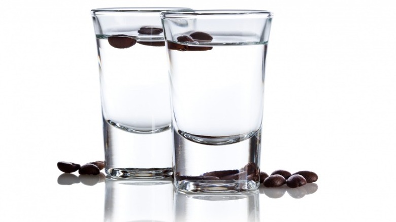 Two Sambuca shots with coffee beans