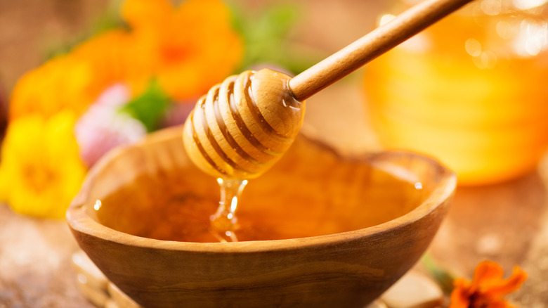 A wooden bowl full of honey