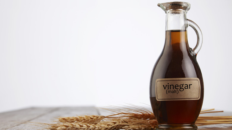 Malt vinegar next to stalks of wheat