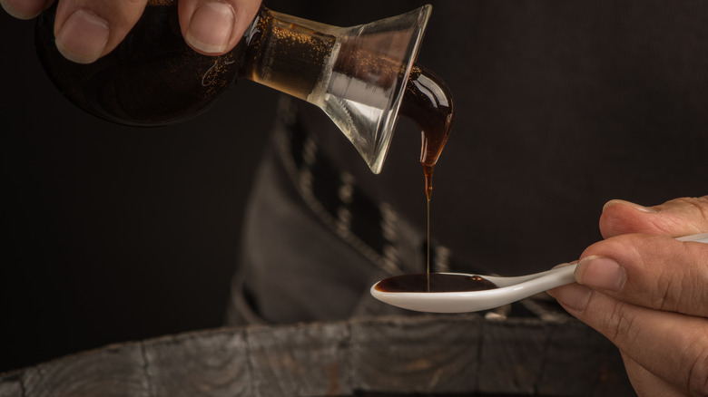 pouring balsamic vinegar into a spoon