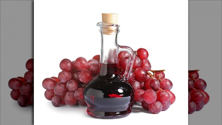 red wine vinegar with red grapes behind it