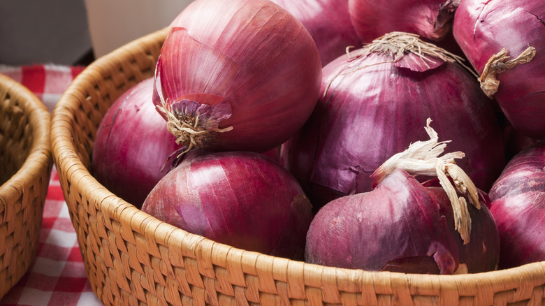 red whole onions in basket