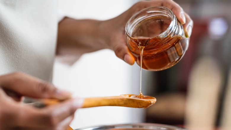 pouring honey into spoon