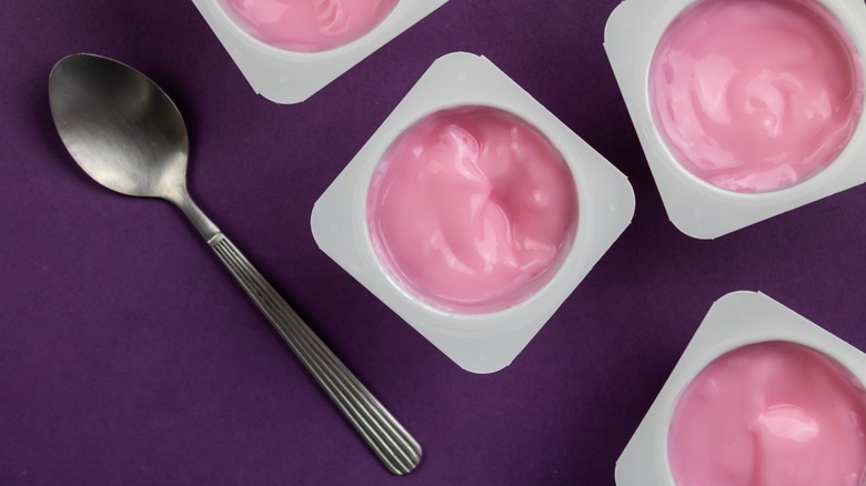 Spoon and single-serve strawberry yogurts