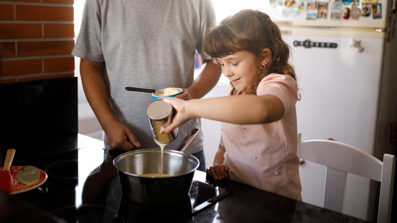 Girl pouring condensed milk 