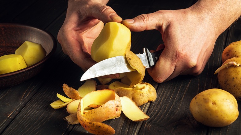 Peeling a potato by hand