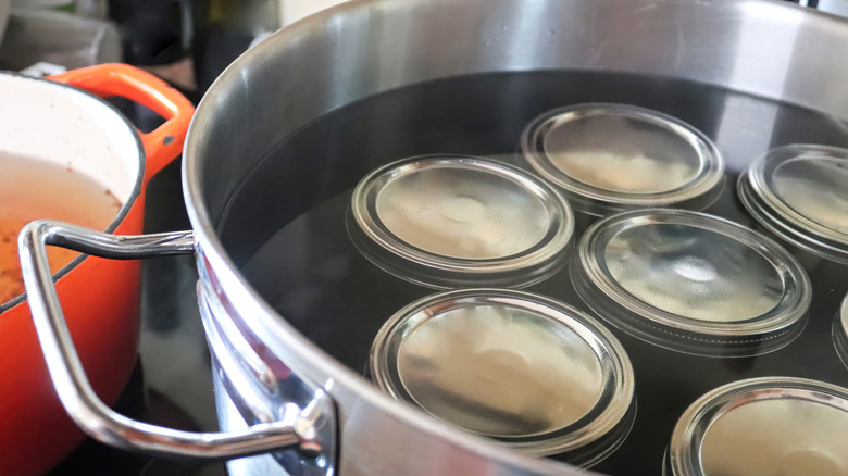 Pickle jars in pot of water