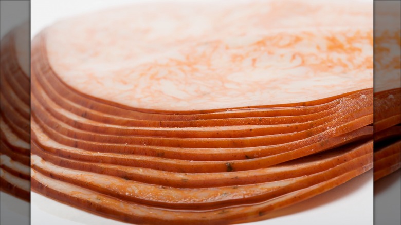 A deli ham is stacked in slices.