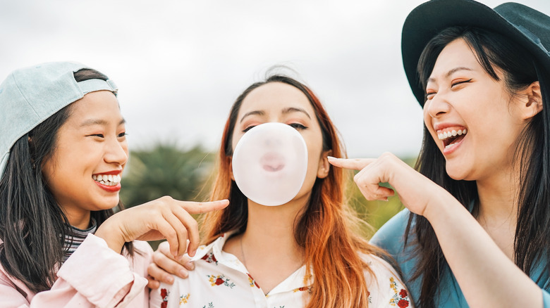 friends blowing bubble gum