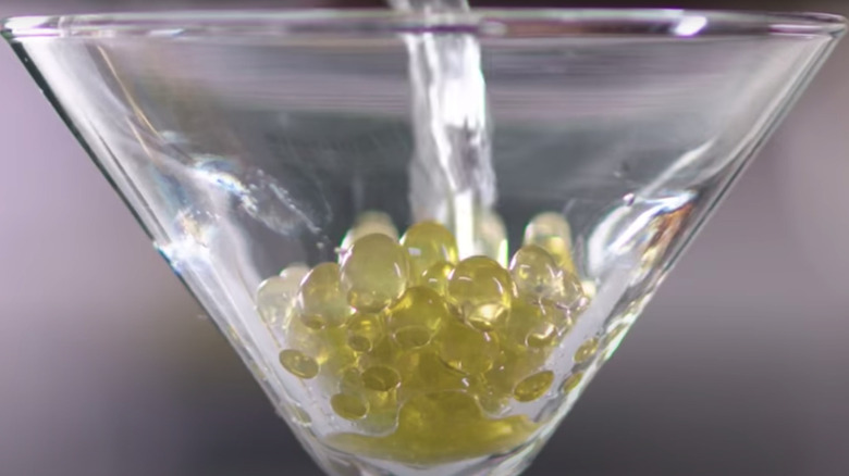 olive juice pearls in a martini glass