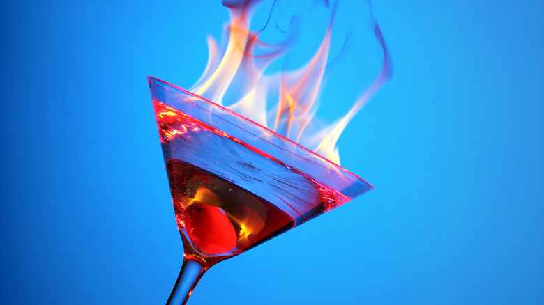 Flaming cocktail in martini glass