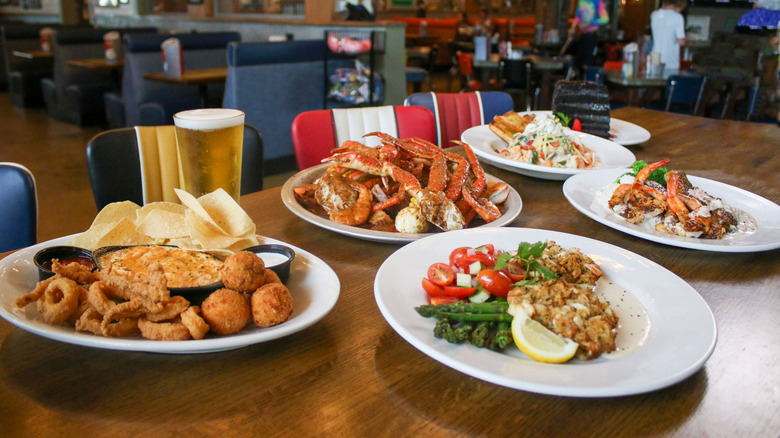 Plates of seafood on table with beer