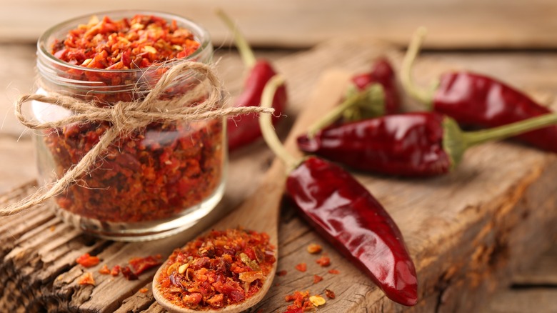 Jar of red pepper flakes with spoon