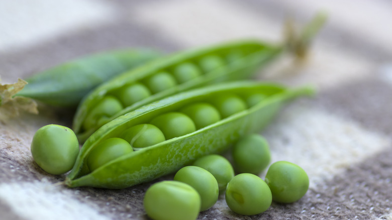 Peas in pod on tablecloth