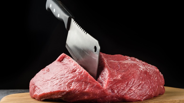 Raw meat cut with knife 