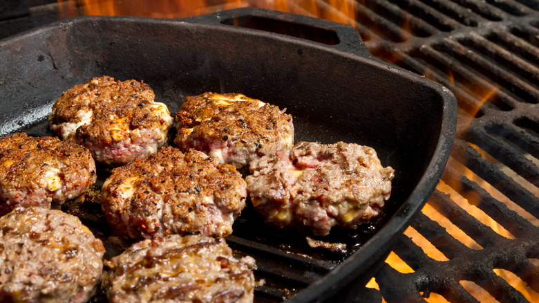 cooking burgers in a cast iron skillet