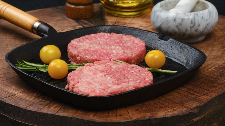 cooking a burger on a cast-iron skillet