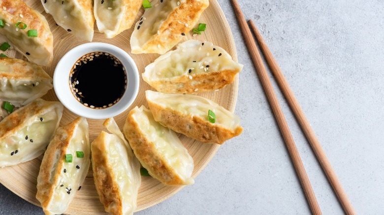 dumplings with chopsticks and sauce